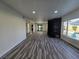Spacious living room with fireplace, wood-look floors, and natural light at 3056 Garnet Ct, Las Vegas, NV 89121