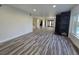 Open living room with wood-look floors, fireplace, and access to the staircase at 3056 Garnet Ct, Las Vegas, NV 89121