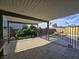 Covered tile patio looks out to green backyard, privacy fences and a pool at 3056 Garnet Ct, Las Vegas, NV 89121