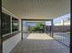 Covered tiled patio with access to the backyard, block wall and metal fence at 3056 Garnet Ct, Las Vegas, NV 89121