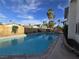 Enjoy the backyard oasis with a sparkling pool, diving board, and mature palm trees at 3056 Garnet Ct, Las Vegas, NV 89121