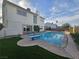 Enjoy the backyard pool with a diving board and lush green artificial turf for lounging at 3056 Garnet Ct, Las Vegas, NV 89121
