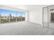 Bright bedroom featuring carpet floors, a sliding glass door leading to a balcony with city views at 3111 Bel Air Dr # 24G, Las Vegas, NV 89109