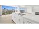 Modern kitchen island with stainless steel appliances, white cabinets, and stunning city views at 3111 Bel Air Dr # 24G, Las Vegas, NV 89109