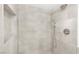 Modern shower featuring gray tile, dual shower heads, and a built-in nook for toiletries at 3111 Bel Air Dr # 24G, Las Vegas, NV 89109