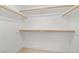 Walk-in closet with built-in shelving and wood floors at 3111 Bel Air Dr # 24G, Las Vegas, NV 89109