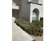Exterior view of a home with lush landscaping and an arched window at 3150 Soft Breezes Dr # 1033, Las Vegas, NV 89128