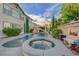 Stunning backyard featuring a pool, spa, and beautifully landscaped garden with a stone surround at 3632 Red Fir St, Las Vegas, NV 89135