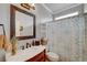 Bathroom featuring a marble countertop vanity, decorative mirror and patterned shower curtain at 3632 Red Fir St, Las Vegas, NV 89135