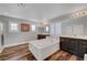 Bright bathroom featuring a large soaking tub, wood-look floors, and and dark wood vanities at 3632 Red Fir St, Las Vegas, NV 89135