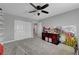 Carpeted bedroom featuring a ceiling fan, natural light, double closet, and decorative wall art at 3632 Red Fir St, Las Vegas, NV 89135
