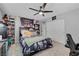 Carpeted bedroom featuring a ceiling fan, natural light, double closet, and desk area at 3632 Red Fir St, Las Vegas, NV 89135