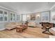 Bright living room with wood floors, neutral paint, shutters, foosball table and plenty of natural light at 3632 Red Fir St, Las Vegas, NV 89135