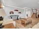 Spacious living room with hardwood floors, foosball table, staircase, and neutral color palette at 3632 Red Fir St, Las Vegas, NV 89135