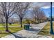 Beautiful park featuring paved walkways, mature trees, seating, and well-maintained landscaping at 3632 Red Fir St, Las Vegas, NV 89135