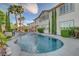 A luxurious backyard pool and spa featuring lush tropical landscaping and a serene setting at 3632 Red Fir St, Las Vegas, NV 89135