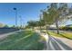 Scenic walking path through the community with mature trees and lush landscaping on a sunny day at 3632 Red Fir St, Las Vegas, NV 89135