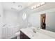 Bright bathroom features a walk-in tub, white vanity, and a mirrored cabinet for ample storage at 371 Legacy Dr, Henderson, NV 89014