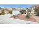 Exterior shot of home showcasing desert landscaping, a two-car garage, and neutral paint scheme at 371 Legacy Dr, Henderson, NV 89014