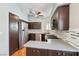 A contemporary kitchen featuring stainless steel appliances, dark cabinetry, and a ceiling fan at 371 Legacy Dr, Henderson, NV 89014