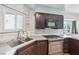 A contemporary kitchen featuring stainless steel appliances, dark cabinetry, and light countertops at 371 Legacy Dr, Henderson, NV 89014