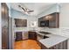 A contemporary kitchen featuring stainless steel appliances, dark cabinetry, and light countertops at 371 Legacy Dr, Henderson, NV 89014