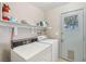 Functional laundry room with washer, dryer, storage shelf, and exterior access at 371 Legacy Dr, Henderson, NV 89014