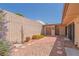 Private backyard featuring a brick patio, decorative rock, and low-maintenance landscaping at 3815 Atlantis St, Las Vegas, NV 89121