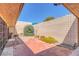 Private backyard with brick patio, rock accents, and simple desert landscaping at 3815 Atlantis St, Las Vegas, NV 89121
