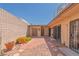 Enclosed backyard with brick patio, desert landscaping, and a private outdoor space at 3815 Atlantis St, Las Vegas, NV 89121