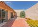 Backyard featuring a brick patio, rock accents, and low-maintenance landscaping at 3815 Atlantis St, Las Vegas, NV 89121