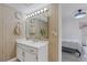 Well-lit bathroom featuring a vanity with a bright white countertop and a view of the bedroom at 3815 Atlantis St, Las Vegas, NV 89121