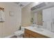 Cozy bathroom featuring wood-style wall paper, a neutral tile floor, and updated hardware at 3815 Atlantis St, Las Vegas, NV 89121