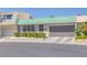 Charming single-story home featuring a green tile roof and well-manicured front yard landscaping at 3815 Atlantis St, Las Vegas, NV 89121