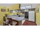 Bright kitchen with a breakfast bar, white appliances, and gray cabinetry at 3815 Atlantis St, Las Vegas, NV 89121