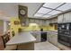 Functional kitchen with a breakfast bar, tile flooring, and stainless steel appliances at 3815 Atlantis St, Las Vegas, NV 89121
