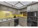 Well-lit kitchen featuring a tile floor, plenty of cabinets, and stainless appliances at 3815 Atlantis St, Las Vegas, NV 89121