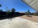 Backyard with concrete and gravel areas and a dark block wall at 3920 Aspencrest Dr, Las Vegas, NV 89108