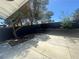 Large concrete patio area in a fenced backyard with mature trees at 3920 Aspencrest Dr, Las Vegas, NV 89108