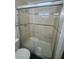 Bright walk-in shower with tiled walls and glass sliding door at 3920 Aspencrest Dr, Las Vegas, NV 89108