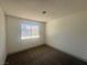 Cozy bedroom featuring neutral-colored carpeting and a window offering plenty of natural light at 3920 Aspencrest Dr, Las Vegas, NV 89108