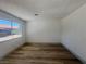 Clean bedroom with wood-look flooring and a large window, providing a bright and welcoming atmosphere at 3920 Aspencrest Dr, Las Vegas, NV 89108