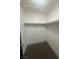 Walk-in closet featuring wraparound shelving and carpeting at 3920 Aspencrest Dr, Las Vegas, NV 89108