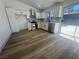 Updated kitchen features modern stainless steel appliances, white cabinets, and beautiful wood-look floors at 3920 Aspencrest Dr, Las Vegas, NV 89108