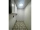 Bright laundry room featuring custom tile floor and plenty of cabinet space at 3920 Aspencrest Dr, Las Vegas, NV 89108
