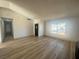 Bright living room features new wood-look flooring and a large window for ample natural light at 3920 Aspencrest Dr, Las Vegas, NV 89108