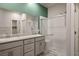Bathroom featuring double sinks with granite counters and a frameless glass shower at 393 Mullen Ave, Henderson, NV 89044