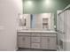 Bathroom featuring double sinks with granite counters and a frameless glass shower at 393 Mullen Ave, Henderson, NV 89044