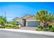 Landscaped single-story home boasts a well-manicured lawn and a paved driveway at 393 Mullen Ave, Henderson, NV 89044