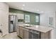 Modern kitchen featuring stainless steel appliances and large island with seating at 393 Mullen Ave, Henderson, NV 89044